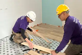 Malcolm laying floors during a house renovation