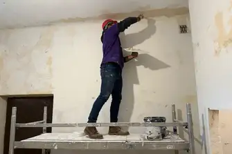 Nik tries his hand at plastering