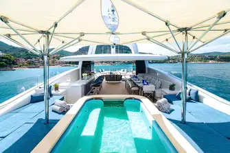 A huge sun deck has a bar, BBQ, dining, lounging, sun and shade as required, and a 10-person pool