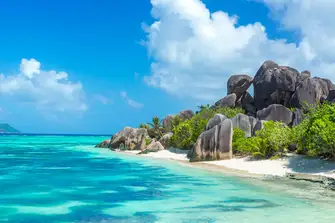 Anse Source d’Argent is famous for luscious coconut palm trees and granite boulders